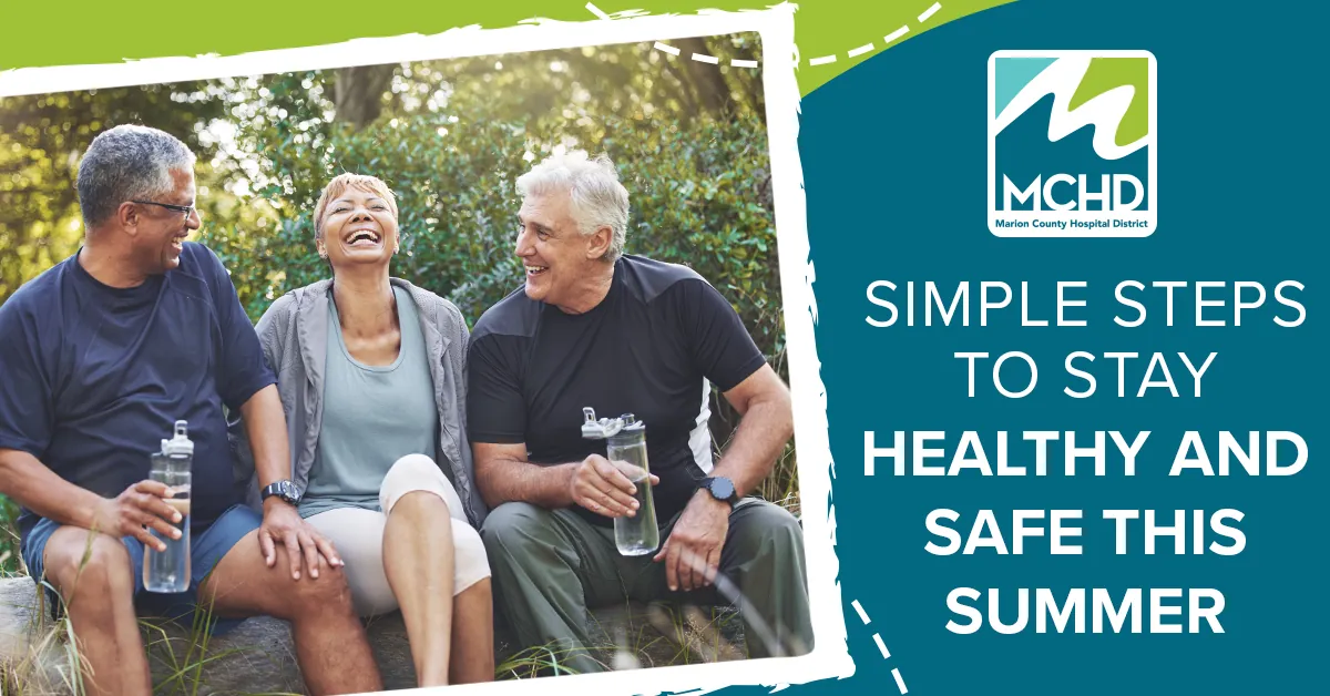 Three adults enjoying an outdoor walk while practicing healthy summer habits and staying hydrated.